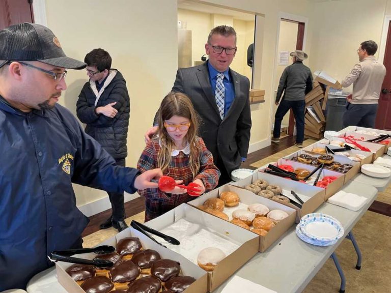 Grand Knight Anthony Estrada, left, with Charlotte Palagi and brother Knight DJ Palagi at donuts and coffee Feb. 4.